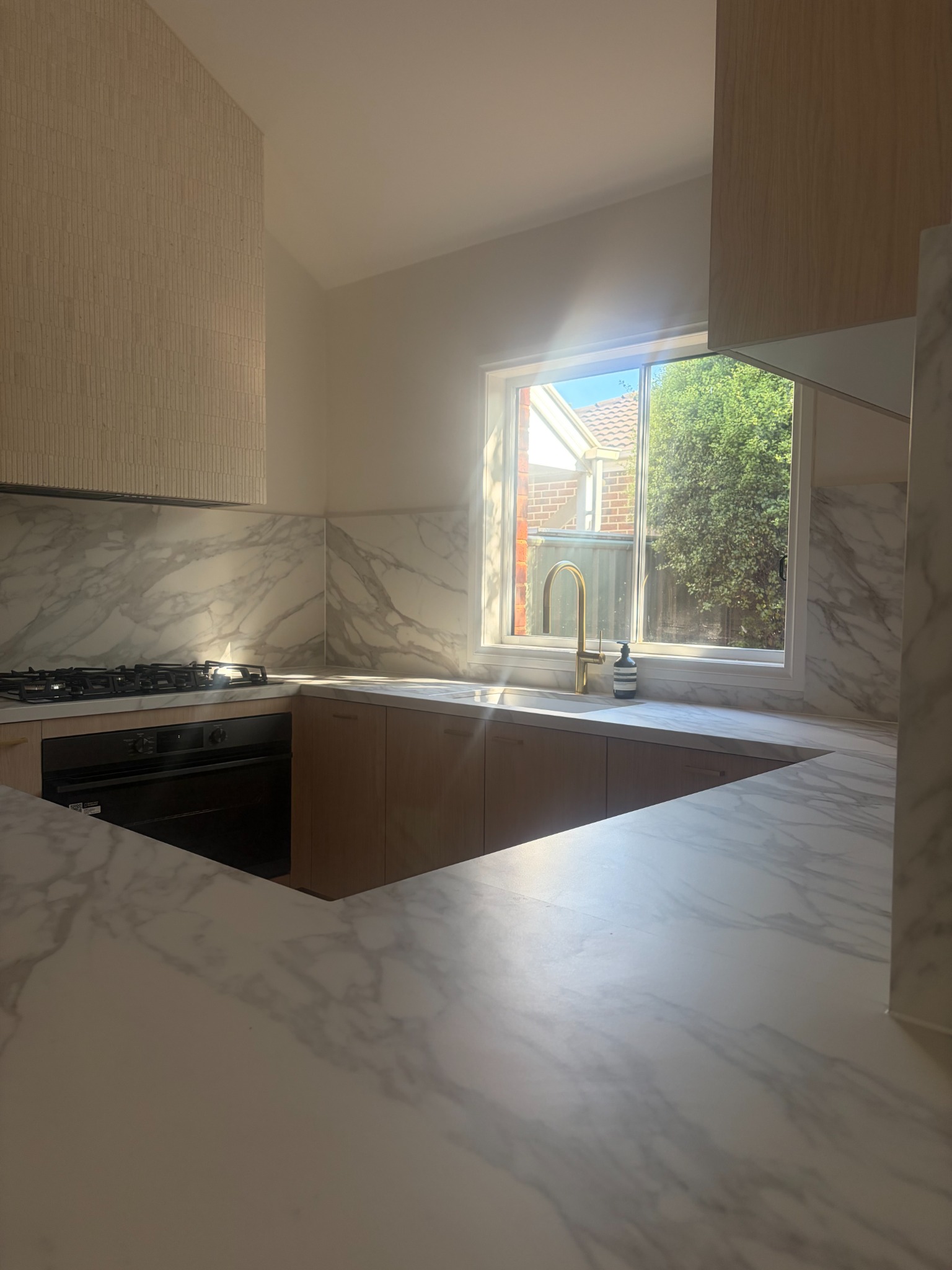 Timber kitchen cabinetry and veined benchtops